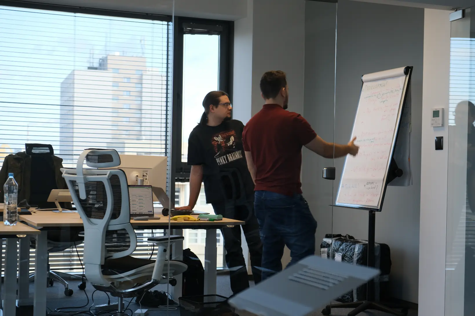 Developers discussing at the whiteboard